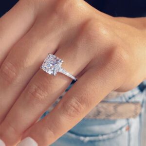 cushion cut engagement rings on hand